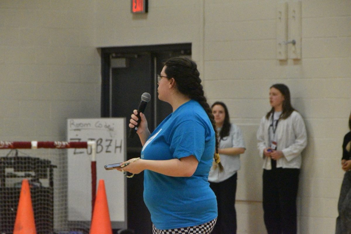 Announcer educating the audience about the hardships in the world that UNICEF will try to fix with the fundraiser.