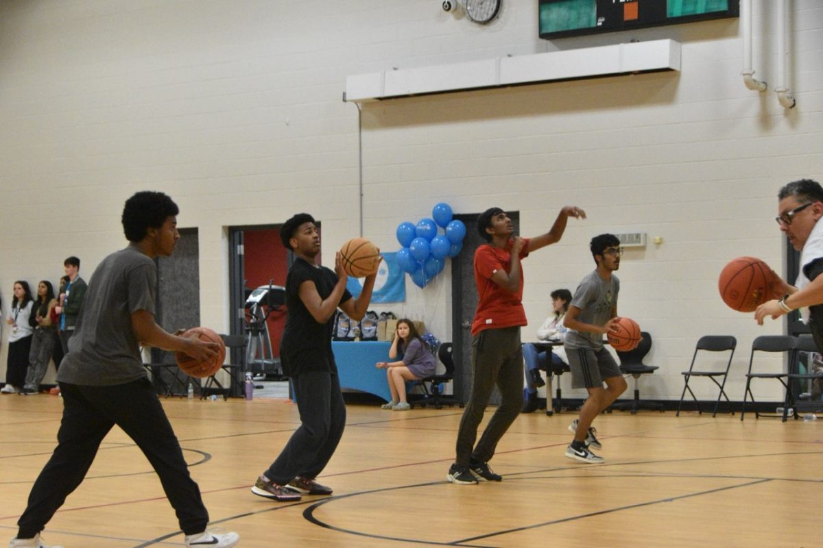 Competitors shooting 3-pointers to get points in the competition.