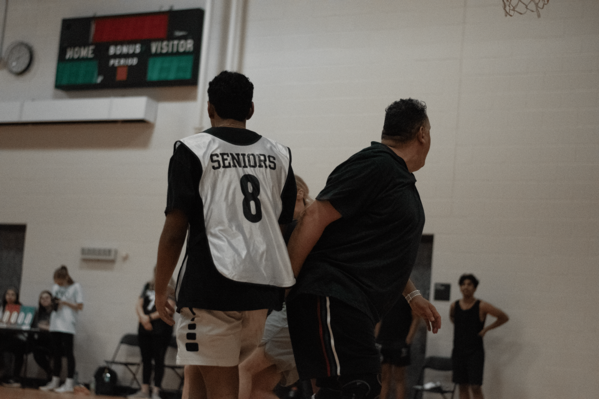 Mr. Granado (right) and a senior during the senior vs facilitator basketball game.