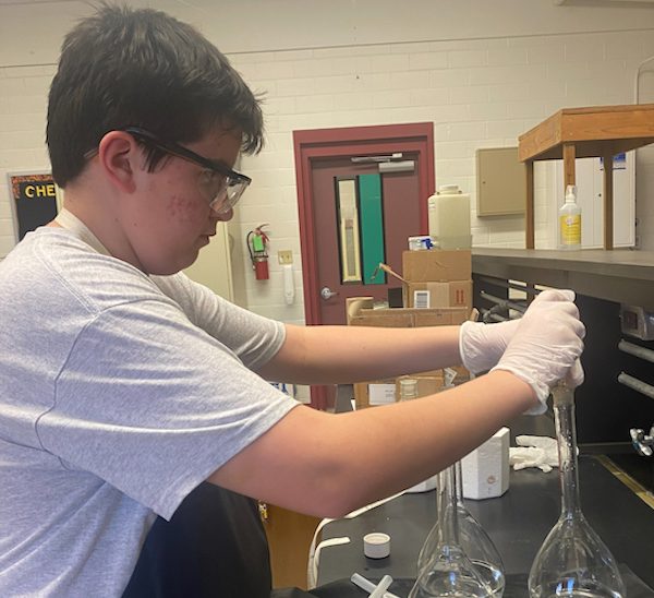 Sam Dondapati adding Phosphoric Acid to the nutrient solution for his project “Growth of Spirulina in Microgravity”. 