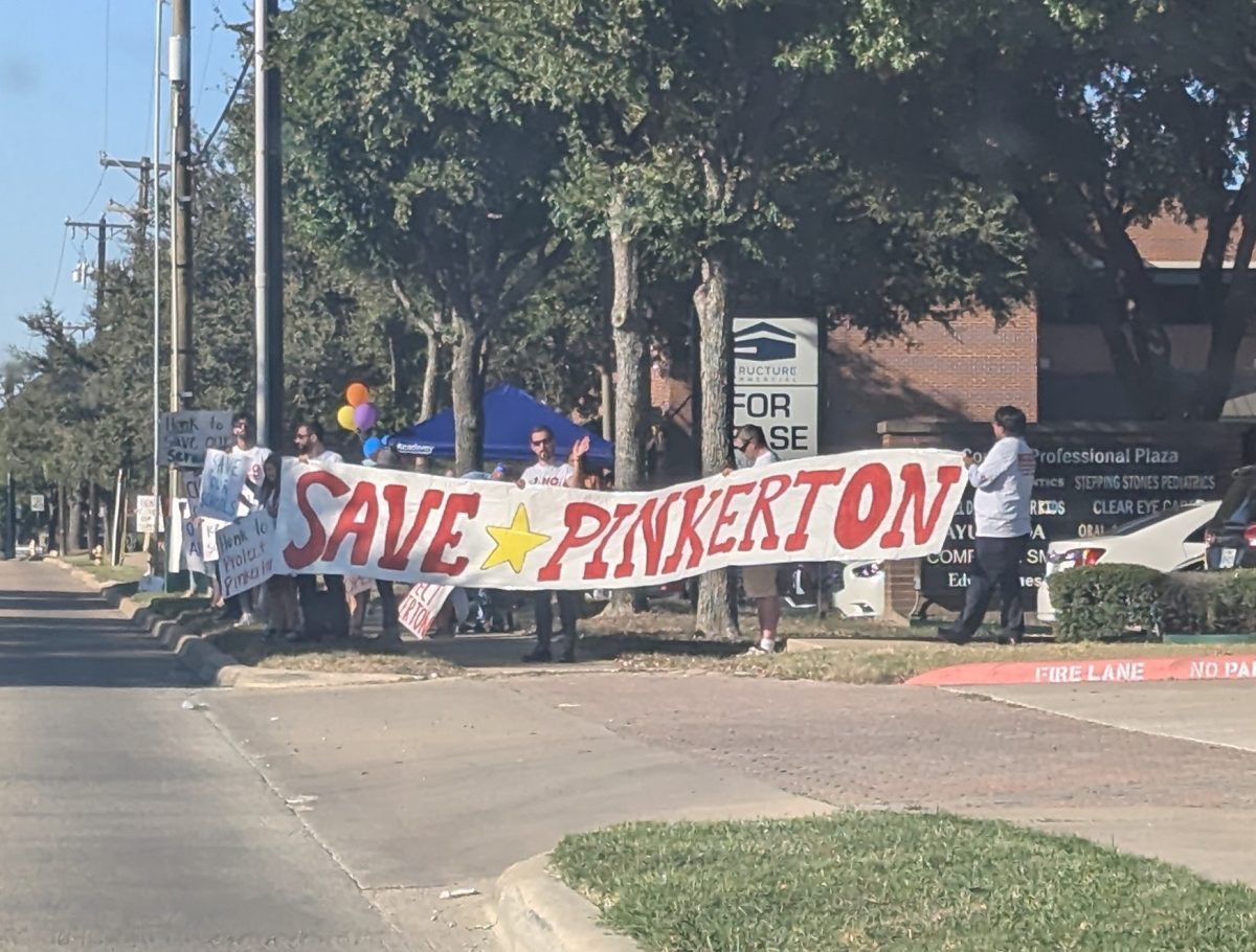 Parents and students holding up signs supporting Pinkerton Elementary
